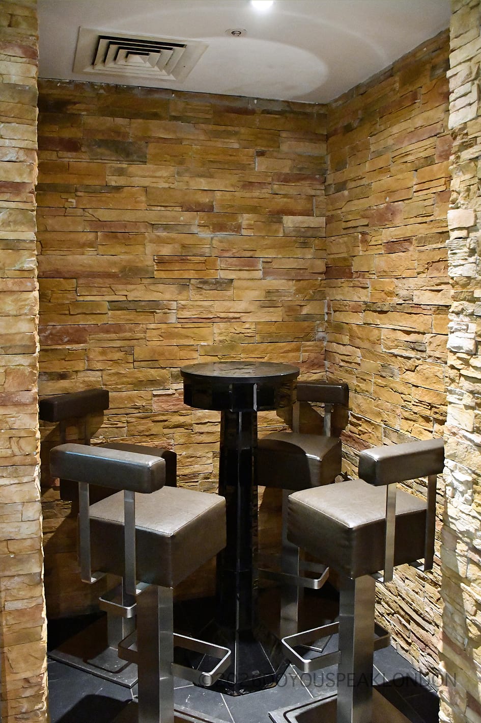 High table in a stone alcove at the Courthouse Hotel bar