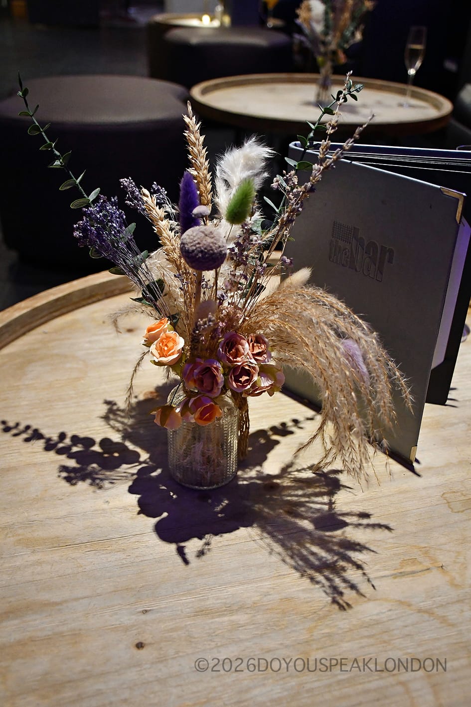 Dried flowers and menu on a barrel table at the Courthouse Hotel cinema