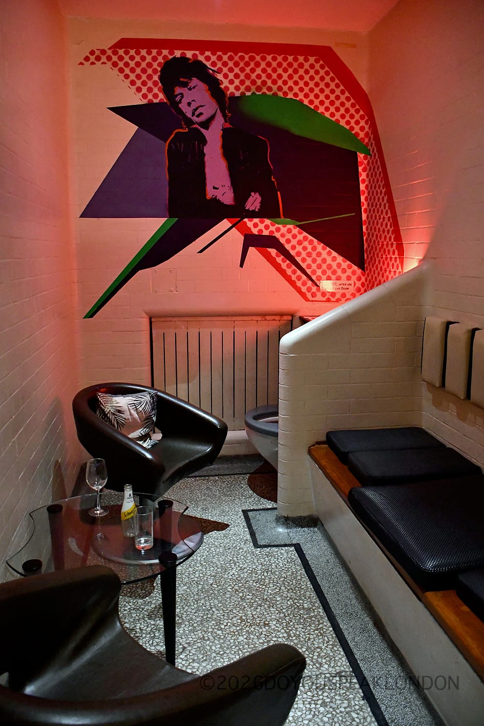 Prison cell booth with pop-art portrait of Mick Jagger at the Courthouse Hotel