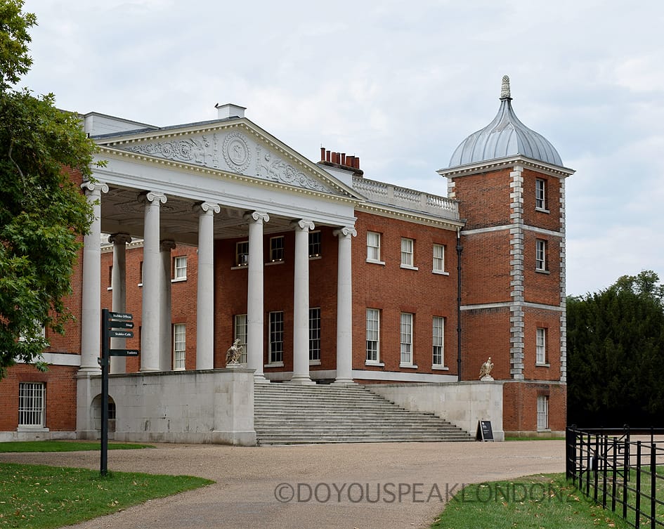 Grand portico with white columns at the entrance of Osterley House