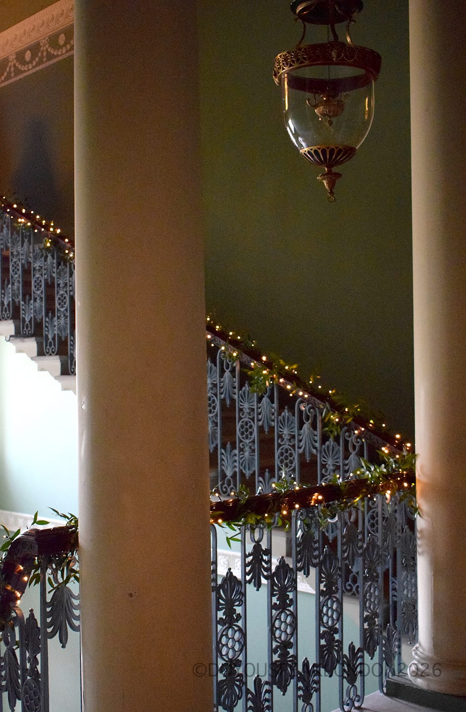 Columns and wrought-iron staircase decorated with garlands inside Osterley House