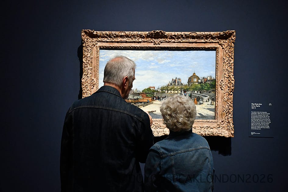 Visitors looking at Renoir's view of the Pont des Arts in Paris at the National Gallery