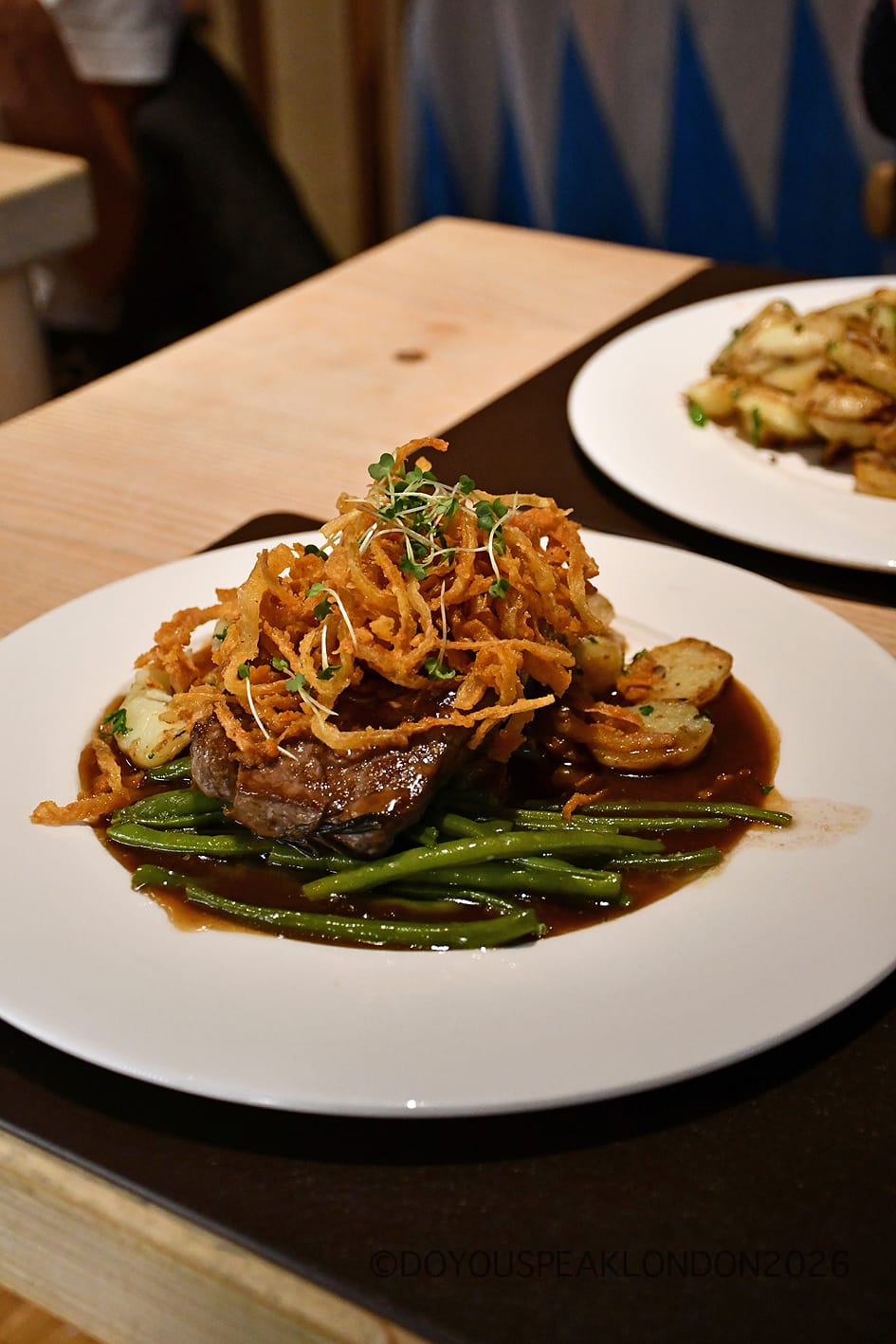 Zwiebelrostbraten roast sirloin steak with crispy onions and green beans at Stein's Berlin