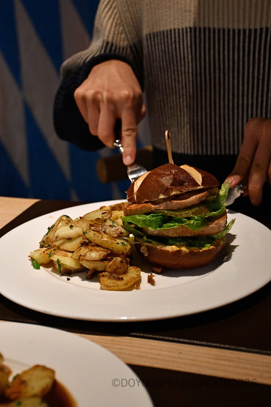 Cutting into the Oktoberfest Leberkäse burger at Stein's Berlin