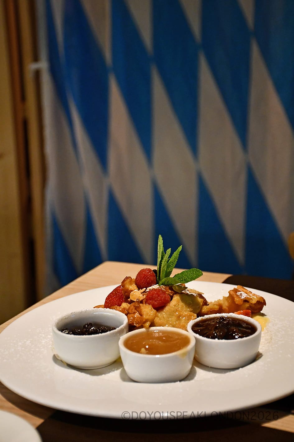 Kaiserschmarrn with three little pots of compote and berries at Stein's Berlin