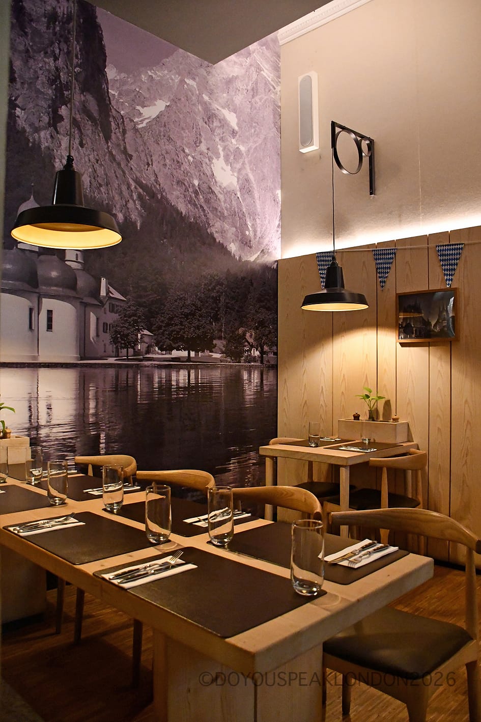 Black and white Alpine lake mural in the dining room of Stein's Berlin