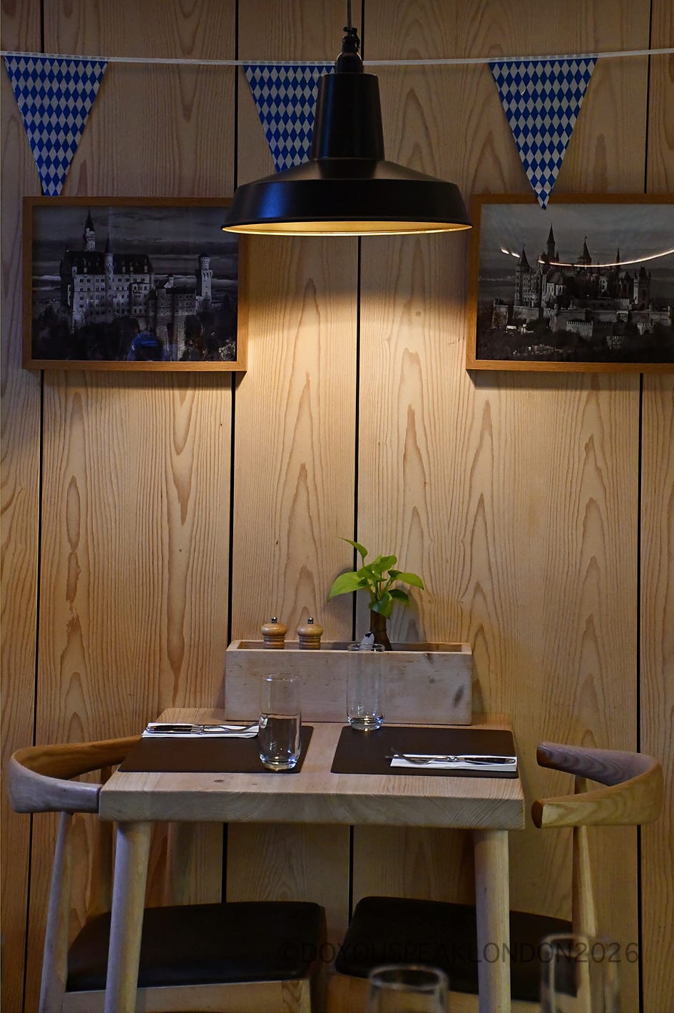 Cosy table under a pendant lamp with Bavarian bunting at Stein's Berlin