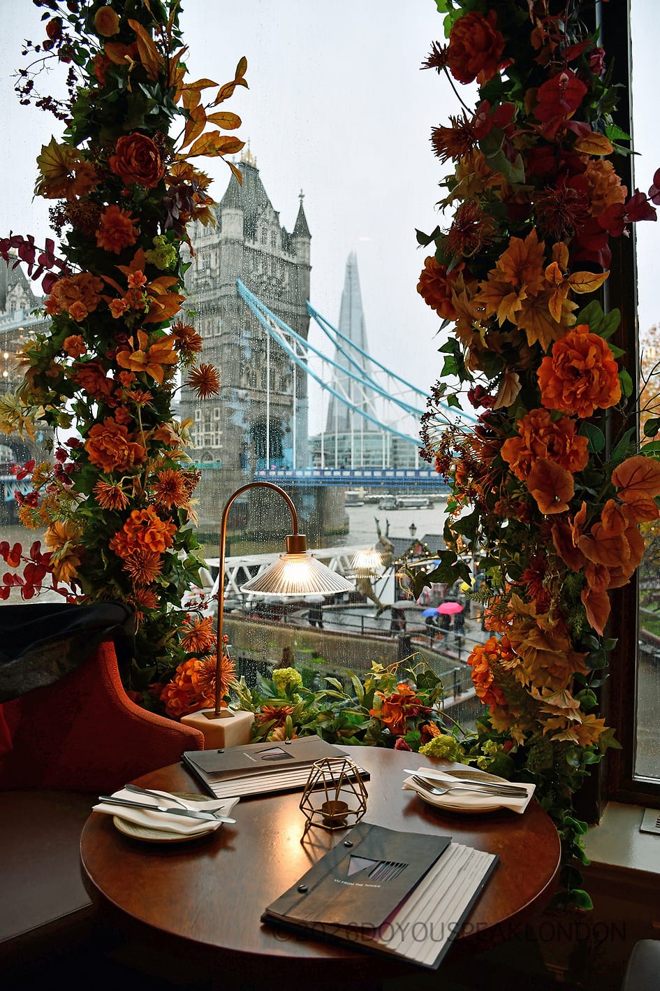 Table with the menu and a view of Tower Bridge and The Shard at VU from The Tower