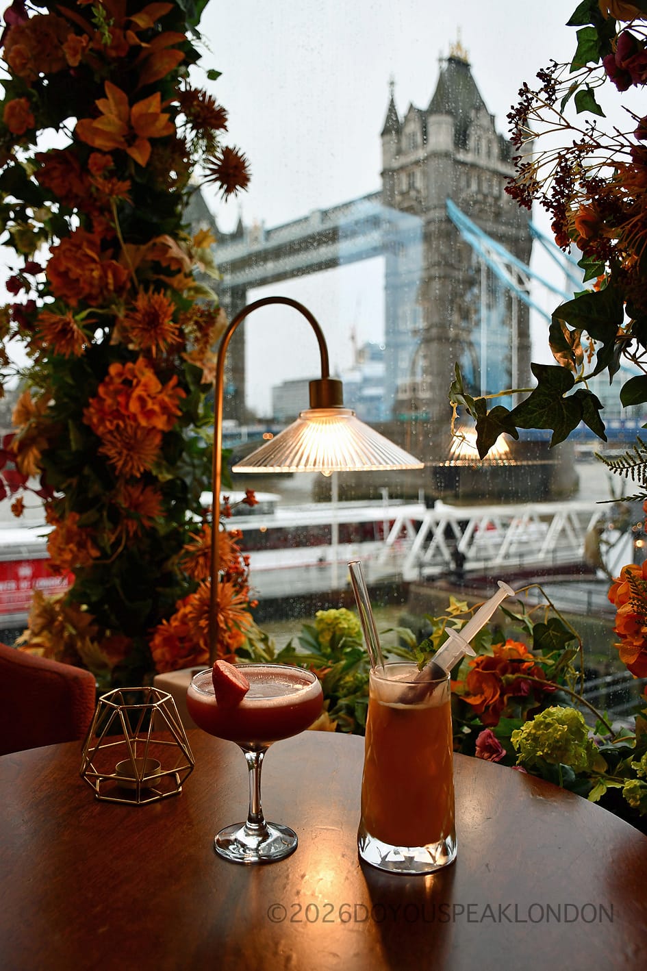 Two cocktails on a table facing Tower Bridge at VU from The Tower