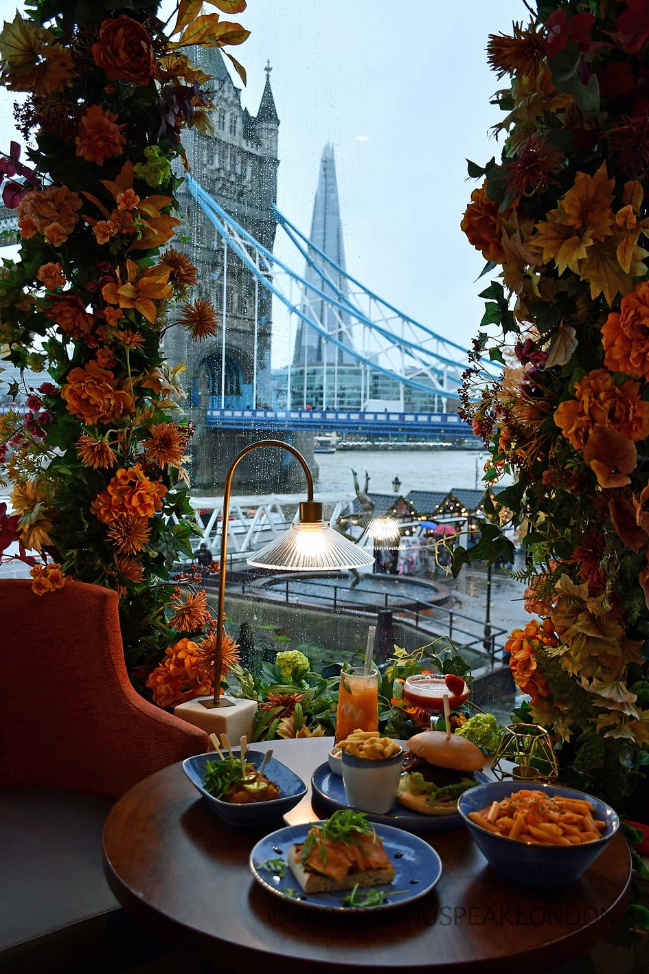 Table set with food and drinks facing Tower Bridge and The Shard at VU from The Tower
