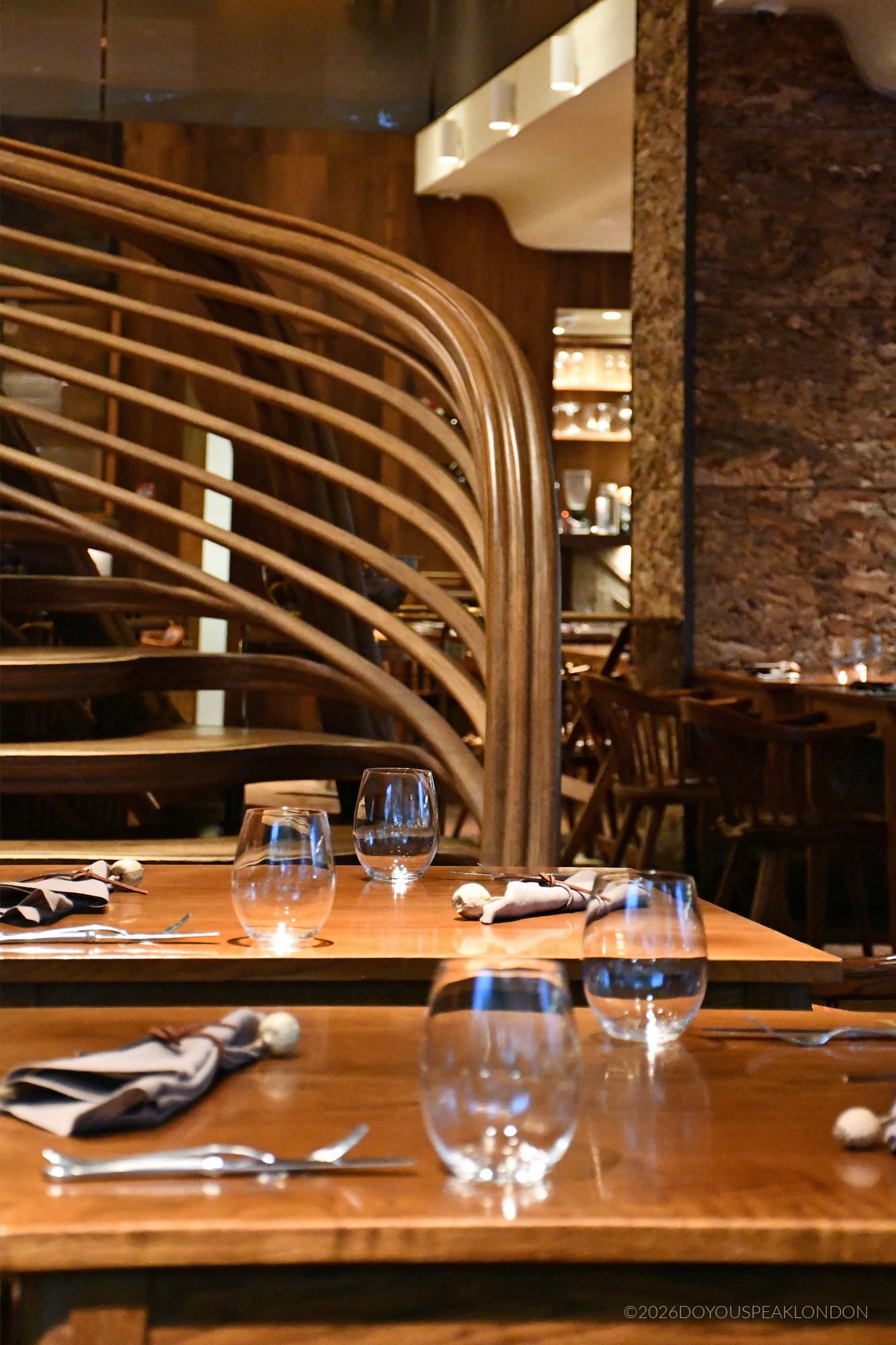 Oak staircase rising above the tables at HIDE
