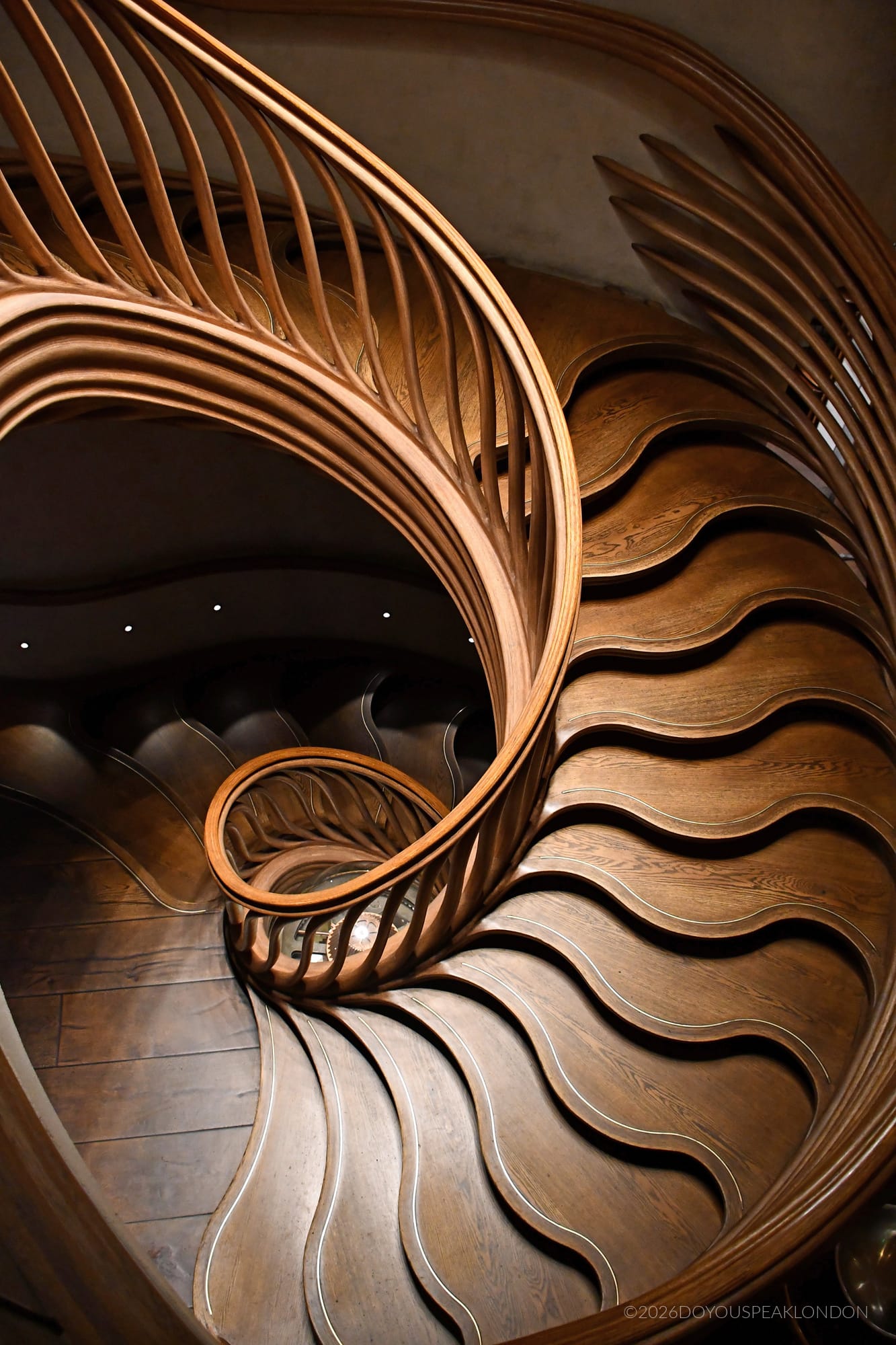 Sinuous oak staircase leading to the bar below at HIDE